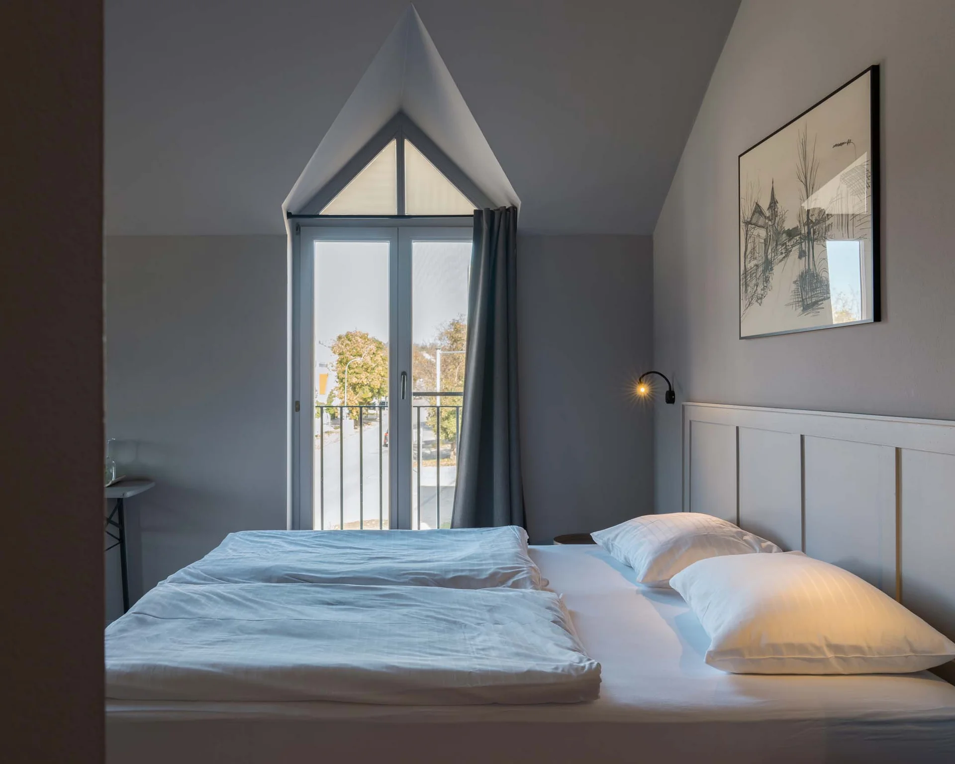 Impressionen aus dem Luis von Weyden Hell eingerichtetes Schlafzimmer mit großer Fensterfront und Doppelbett